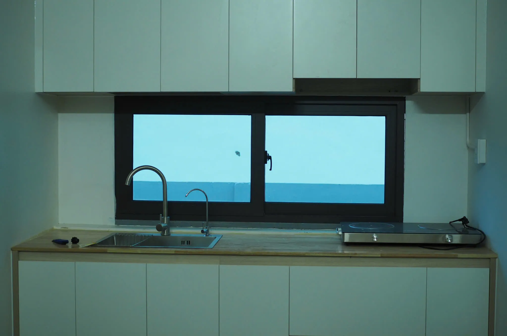 Studio kitchen beside a wide window